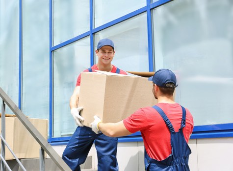 Mover carrying a box during a relocation service