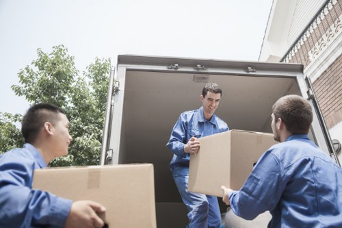 House removalists in Uxbridge carrying furniture through a residential property
