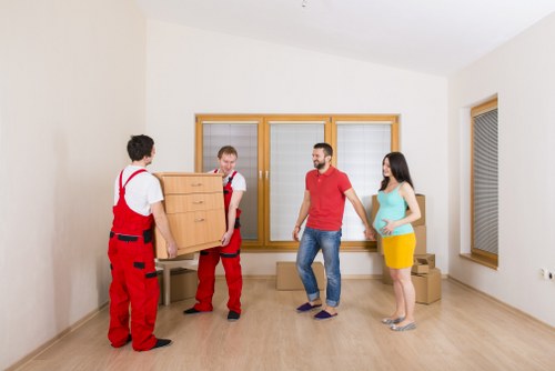 Staff using manual handling aids to move heavy items safely