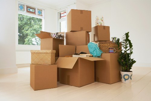 A moving team carefully packing fragile household items in Uxbridge